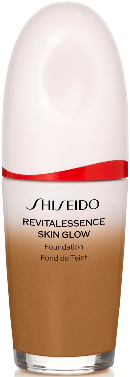 A bottle of Shiseido Revitalessence Skin Glow foundation with a white cap and red design, blending from white to brown.