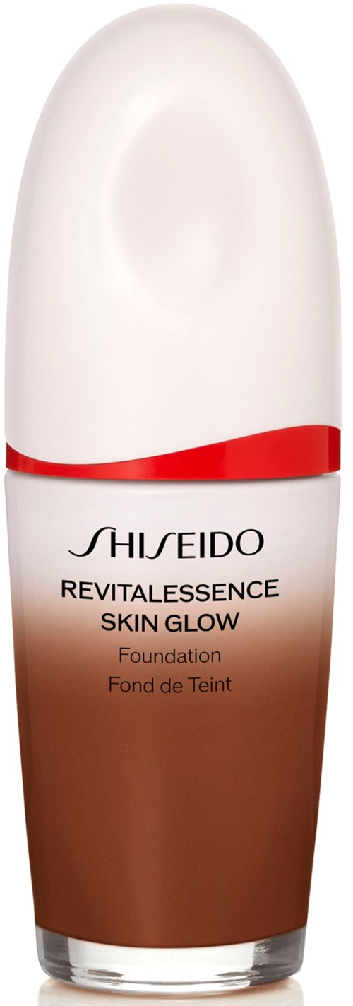 A foundation bottle with a white and brown design, red line, and black text. It is from Shiseido's Revitalessence Skin Glow line.