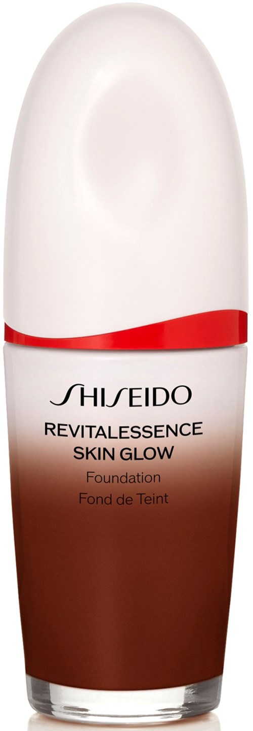 A bottle of Shiseido Revitalessence Skin Glow Foundation with a white top and brown base, featuring a red curved line.