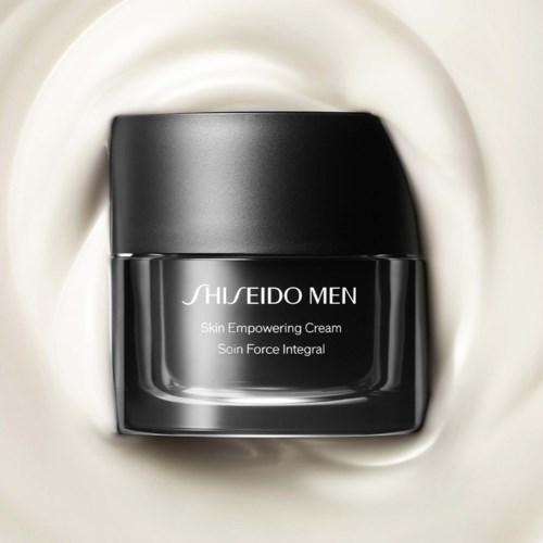A black jar of Shiseido Men skin cream on a cream-colored surface.
