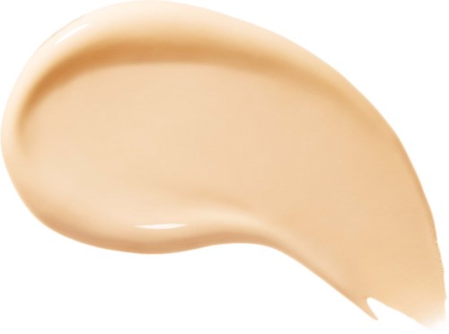 Eine beigefarbene Creme in gebogener Form auf weißem Hintergrund.