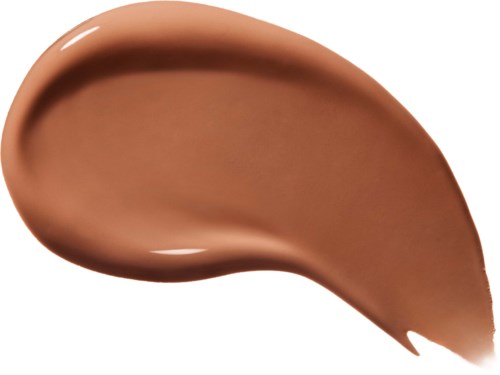 Ein brauner, cremiger Fleck von Make-up oder Lotion auf weißem Hintergrund.