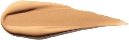 En kladd av beige makeup eller kräm med en spetsig ände på svart bakgrund.