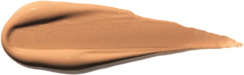 En beige-kräm eller foundation är utbredd på en vit bakgrund, med en liten spetsig ände.