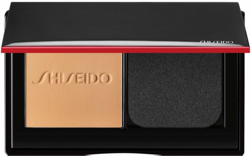 Pieni meikkipakkaus, jossa on puuteri ja sieni, musta ja punainen ja valkoinen reuna, Shiseido-merkkinen.