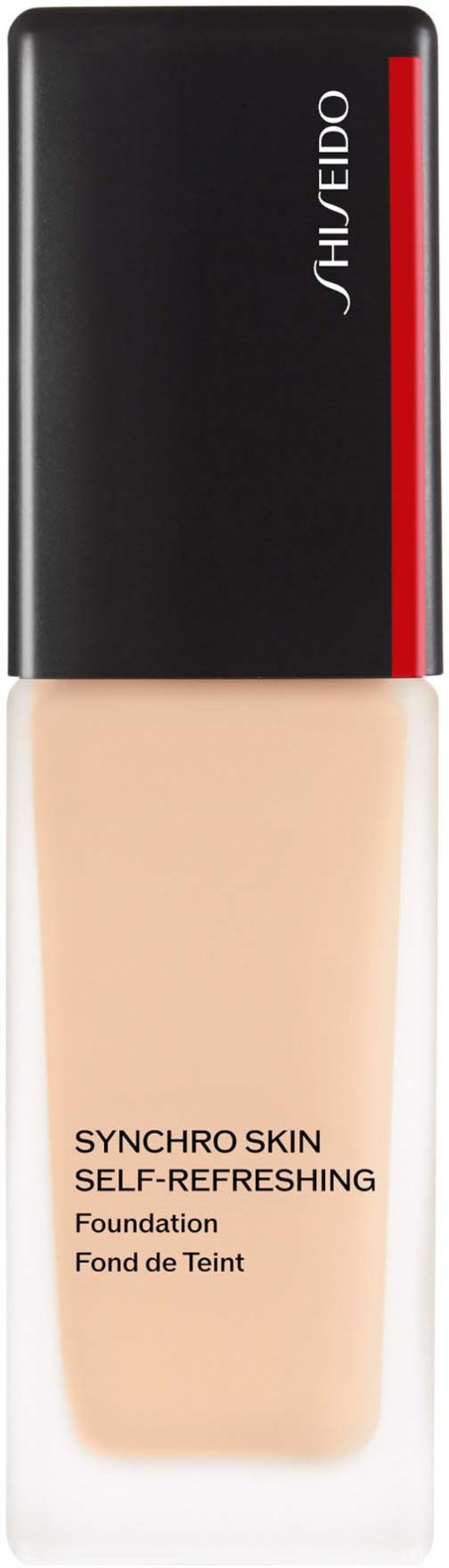 En foundationflaska med svart lock och beige vätska inuti. Den är märkt 'Shiseido Synchro Skin' och 'self-refreshing'.
