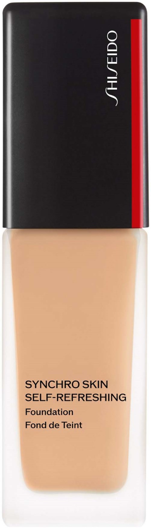 En flaska av Shiseido Synchro Skin foundation, beige färg, svart och röd kork, och produktnamn på framsidan.