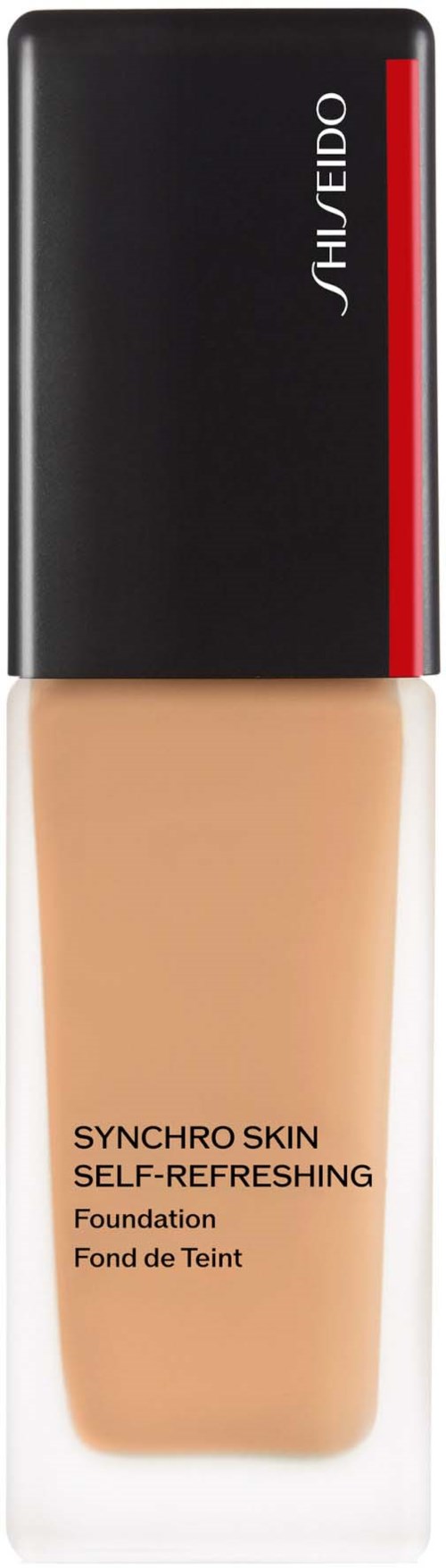 En flaska foundation med svart lock, röd och vit logotyp, beige vätska inuti, märkt Shiseido Synchro Skin.