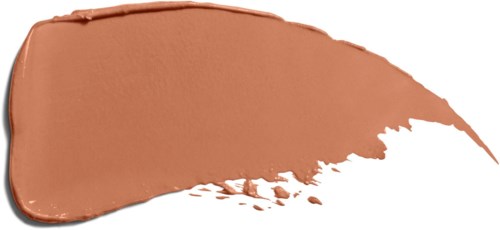A smear of brown makeup or foundation on a white surface, with uneven edges and some scattered product.