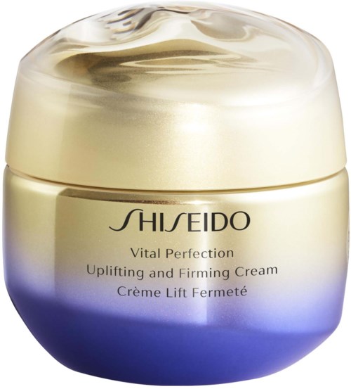 En burk med hudvårdsgrädde, guld- och lila färger, märkt Shiseido Vital Perfection, Uplifting and Firming Cream.