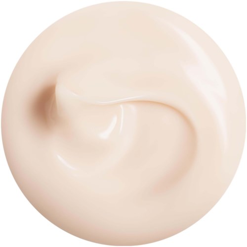 Krämig, slät substans i en virvlande form, ljusbeige färg, glänsande yta.