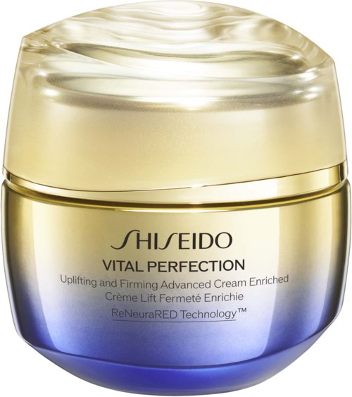 En burk Shiseido Vital Perfection-kräm med en gul och blå behållare och ett glänsande lock.