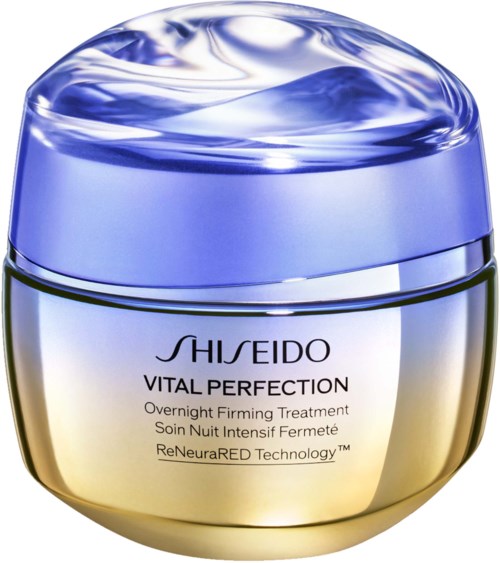 Ein runder Behälter mit glänzendem blauen Deckel und goldfarbenem Körper, gekennzeichnet "Shiseido Vital Perfection Overnight Firming Treatment."