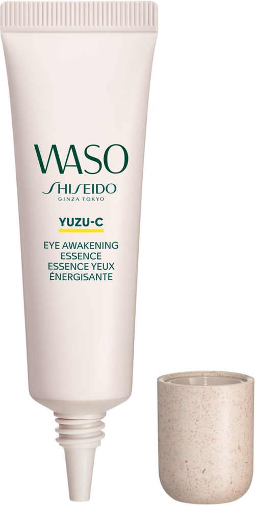 Eine weiße Tube von WASO Yuzu-C Eye Awakening Essence mit beige Kappe daneben.