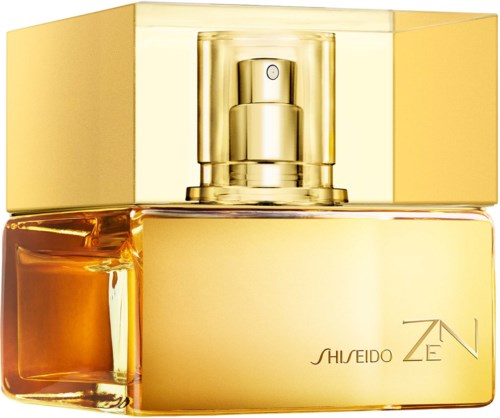 En gyllene parfyllflaska med spray och glänsande lock, märkt Shiseido Zen.