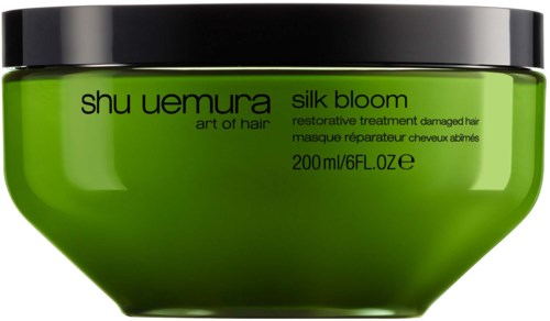 Grüner Behälter mit Shu Uemura Silk Bloom Haarpflege für geschädigtes Haar, 200 ml.