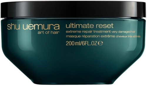 Eine dunkelgrüne Schale mit schwarzem Deckel, beschriftet 'Shu Uemura Ultimate Reset' für Haarreparatur.