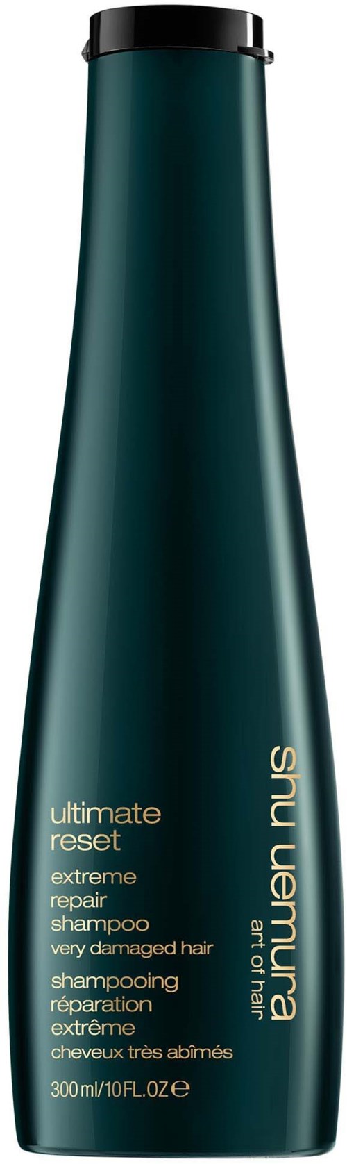 Eine lange, dunkelgrüne Shampoo-Flasche mit schwarzemDeckel und goldener Schrift.