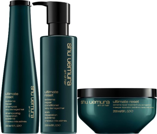 Three hair care products in green bottles and a bowl are shown, labeled for damaged hair repair and reset.