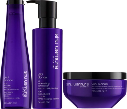 Purple shampoo bottles and a jar from Shu Uemura's Yubi Blonde line for hair care.