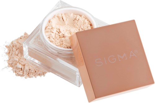 A pink box with the Sigma logo, open powder makeup or face powder next to the box.