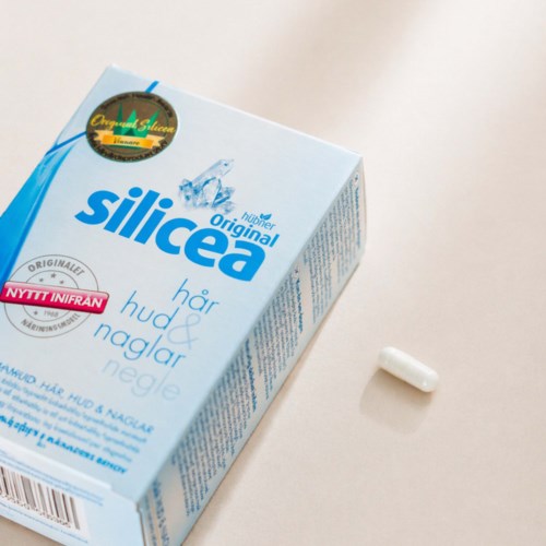 A box of Silicea hair and scalp pills with one pill outside the box on a white background.