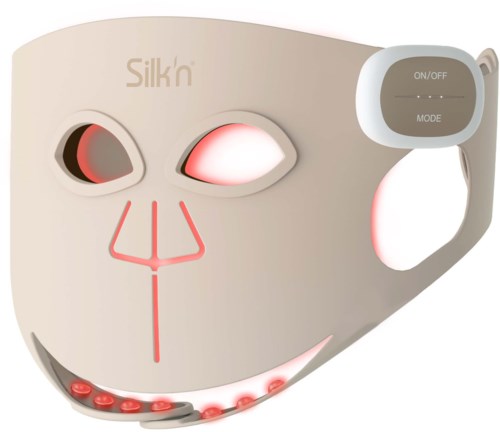 A white facial mask device with illuminated areas, buttons on the side labeled on/off and mode, and small red lights.
