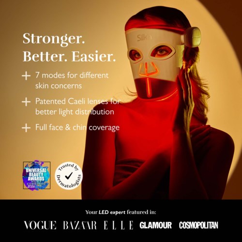 A woman in a red shirt wears a mask with lights, promoting skin care benefits and featuring logos of beauty magazines.