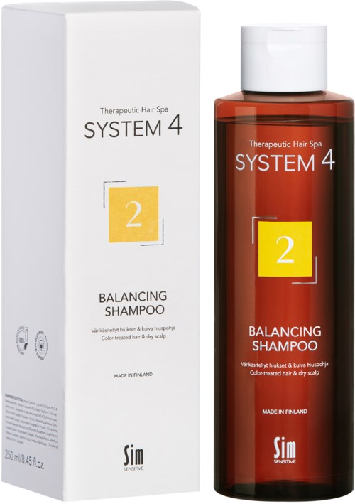 Eine rote Flasche und weiße Verpackung von Balance-Shampoo aus System 4, mit Labels zu therapeutischer Haarspa und Finnland.