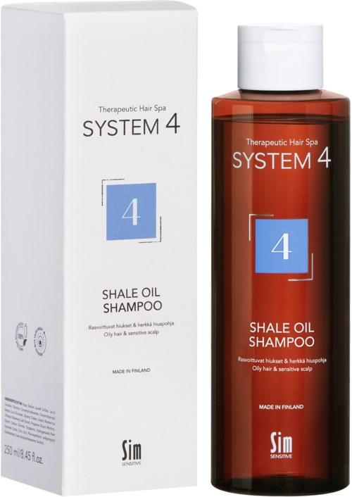 Ein weißer Karton und eine braune Flasche mit Shampoo namens System 4 Shale Oil Shampoo für empfindliche Kopfhaut.