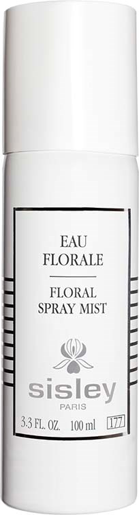 Biała butelka spray noszona etykietą 'Eau Florale' i 'Floral Spray Mist' od Sisley Paris z kwiatowym logo.
