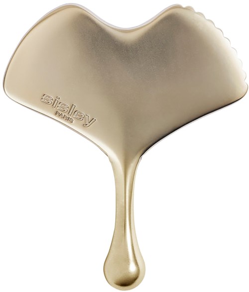 Een goudkleurig metallic voorwerp met een getextureerde zijde en een handvat, waarschijnlijk een haarborstel of verzorgingsgereedschap.