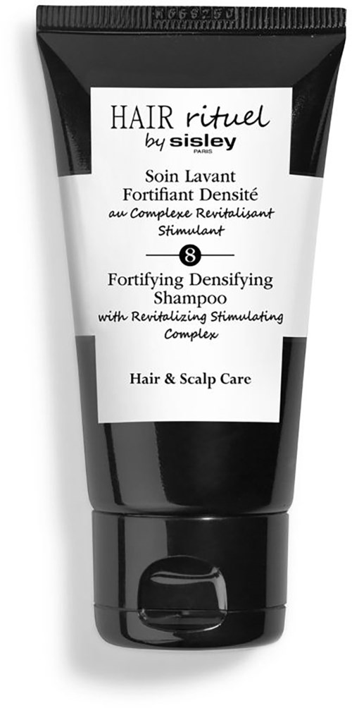A black and white tube of shampoo labeled 'HAIR rituel by sisley', for hair and scalp care, with a focus on revitalizing and fortifying.