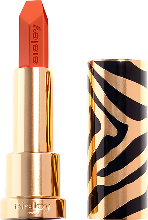 A lipstick with a gold and black striped case, showing red lipstick inside.