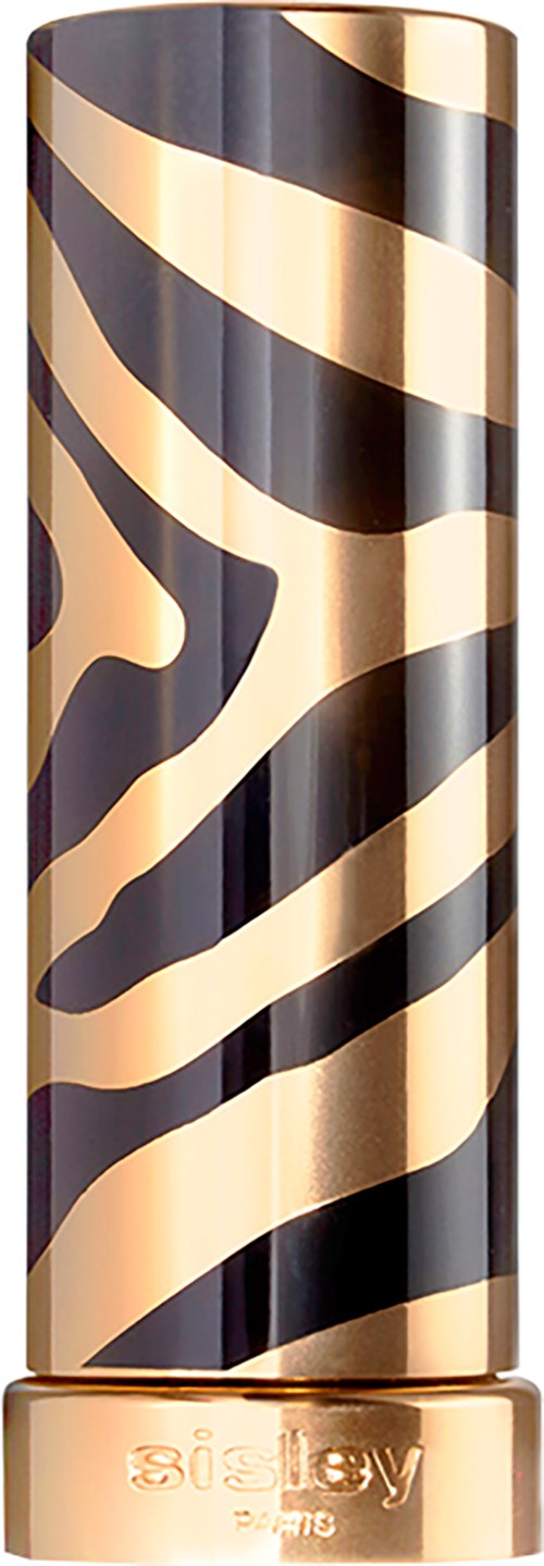 Ett långt cylindriskt föremål med svart och guld zebra-mönster, och guldbas med text. Troligen ett kosmetikaprodukt.