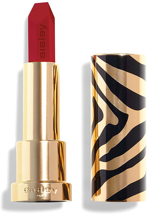 A red lipstick in a gold and black zebra-patterned case with the cap off.