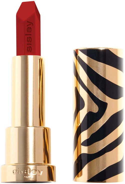 A red lipstick in a gold tube with a black and cream zebra pattern cap.