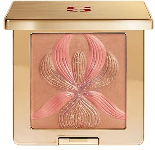 A makeup blush with a floral design in pink and gold inside a shiny gold compact.