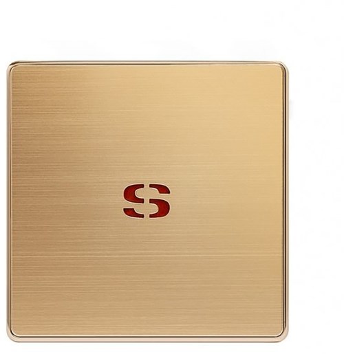 A gold-colored square compact with a red logo in the center.