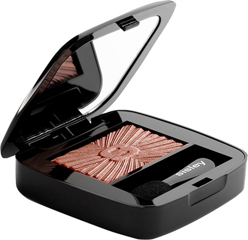 A blush compact with a mirror inside, containing a pinkish powder and an applicator.