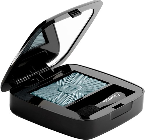 A small, black, open makeup mirror with a compartment holding a circular arrangement of blue mascara or eyelash extensions.