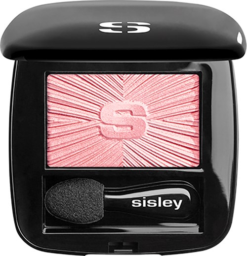 A black compact with bright pink blush powder, a sponge applicator, and the brand name 'Sisley' on the sponge.