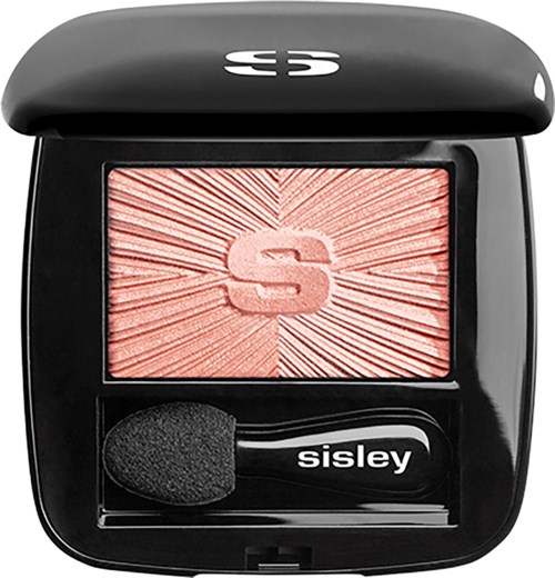 A black compact with a pink blush and a sponge applicator, logo shows on top and in middle of blush.