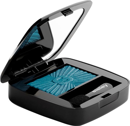 A small, black makeup compact with eyeshadow and a mirror inside, partially open.