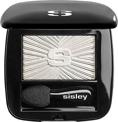 A black compact with a sparkly silver blush and a small applicator brush inside.