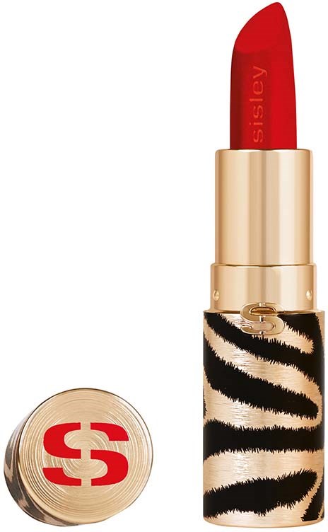 A red lipstick in a gold and zebra-patterned case. The brand name is partially visible on the lipstick.