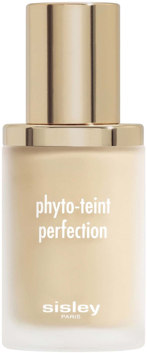 Valkoinen pullo kultaisella suojakorkilla, merkinnällä 'phyto-teint perfection' Sisley Paris, todennäköisesti meikkituote.