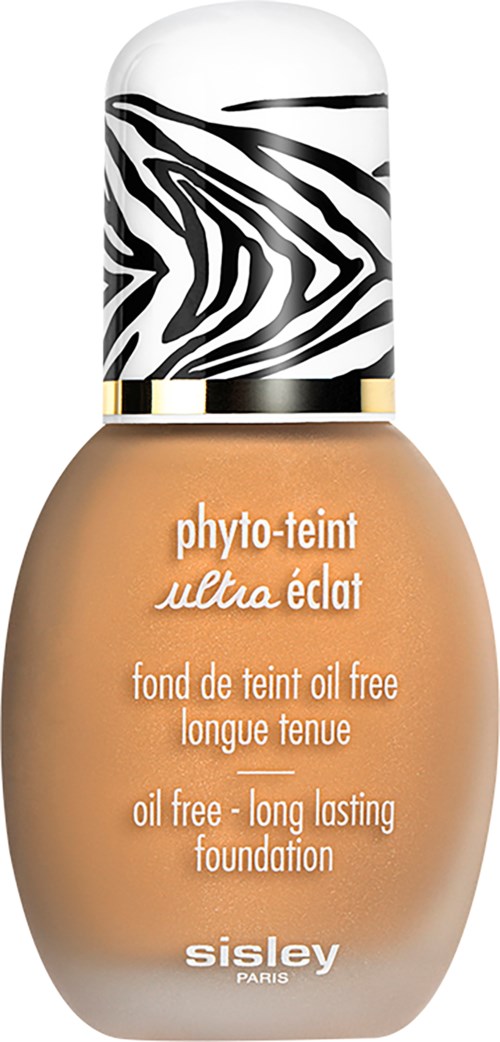 Meikkivoidepullo, jossa on zebra-kuvioinen korkki ja beige neste. Etiketti sanoo, että se on öljytön ja kestää pitkään.