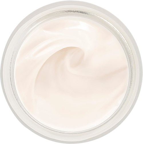 Et glass med lys, kremet lotion eller krem med glatt tekstur inni.