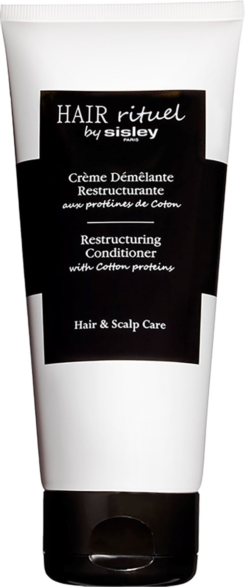 A white tube with black label showing hair care product for restructuring and scalp care with cotton proteins.